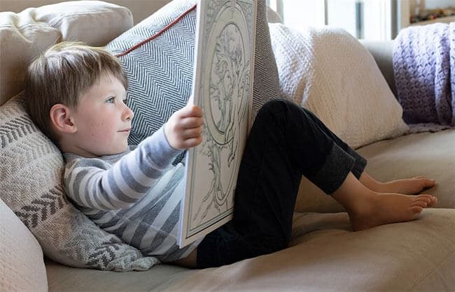 little boy is reading The Blessings Ball